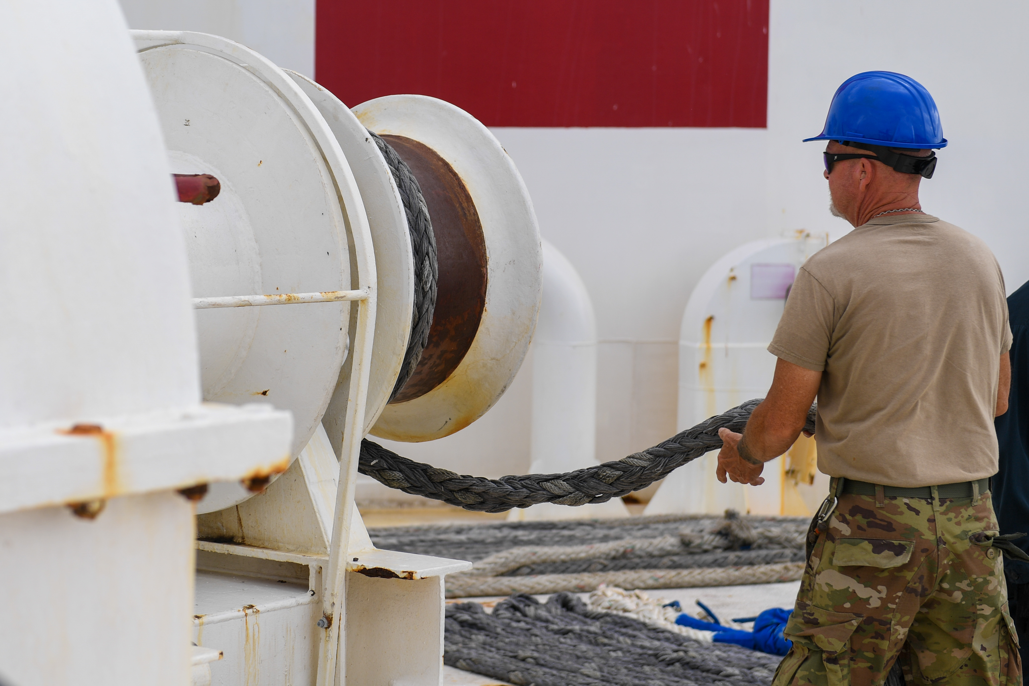 Military Sealift Command Civil Service Mariner Jammie Groot hoists the final line aboard the hospital ship USNS Mercy (T-AH 19) while departing Joint Base Pearl Harbor-Hickam, Hawaii as part of Pacific Partnership 2024-1, Feb. 4, 2024. Pacific Partnership, now in its 19th iteration, is the largest multinational humanitarian assistance and disaster relief preparedness mission conducted in the Indo-Pacific and works to enhance regional interoperability and disaster response capabilities, increase security stability in the region, and foster new and enduring friendships.