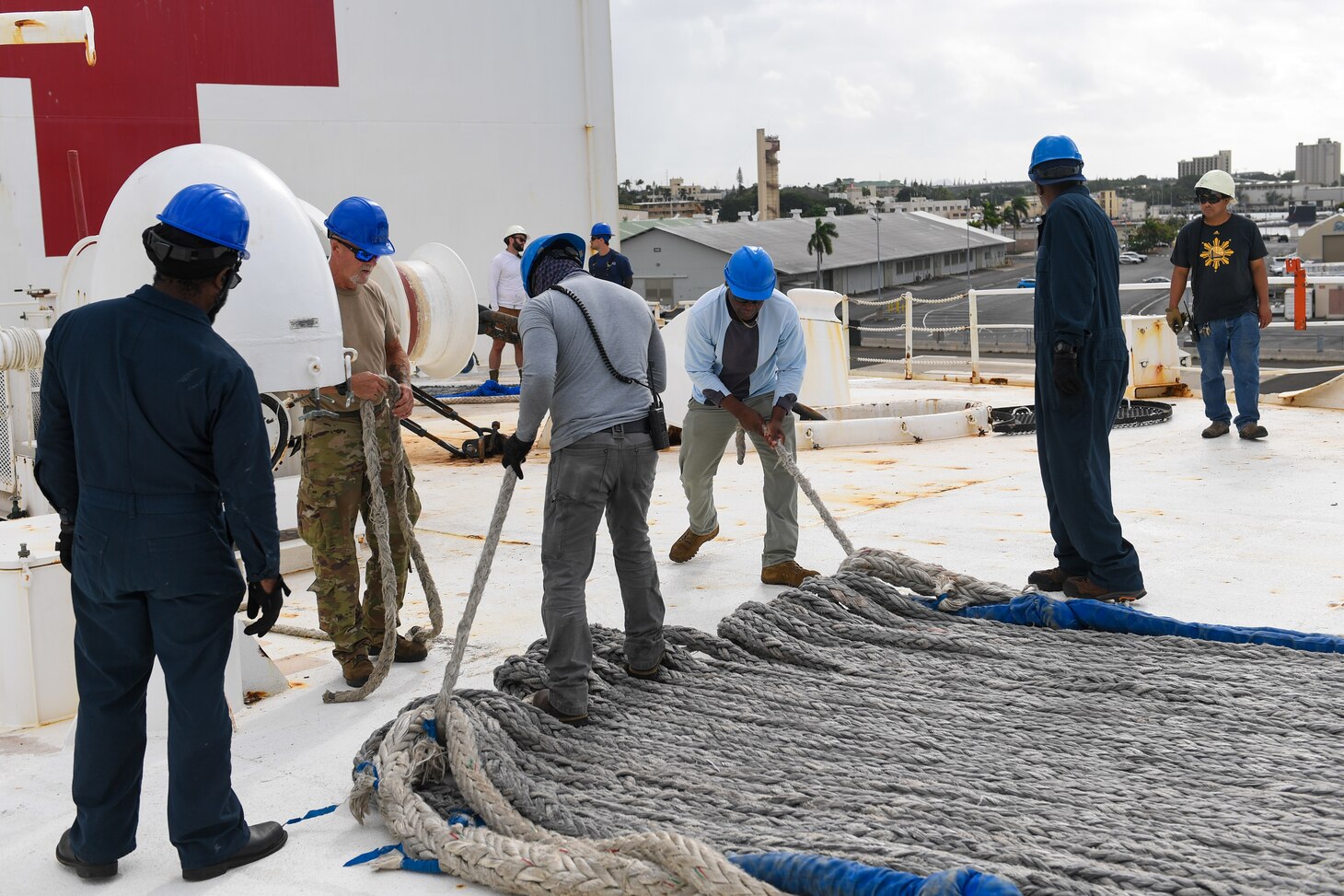 Military Sealift Command Civil Service Mariners stow line aboard the hospital ship USNS Mercy (T-AH 19), casting off from Joint Base Pearl Harbor-Hickam, Hawaii, as part of Pacific Partnership 2024-1, Feb. 5, 2024. Pacific Partnership, now in its 19th iteration, is the largest multinational humanitarian assistance and disaster relief preparedness mission conducted in the Indo-Pacific and works to enhance regional interoperability and disaster response capabilities, increase security stability in the region, and foster new and enduring friendships.