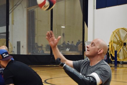Retired Army Master Sgt. Ivan Morera, serving the ball in sitting volleyball practice during the 2025 Team U.S. Invictus Games Training Camp located at Joint Base Lewis-McChord (JBLM), Washington