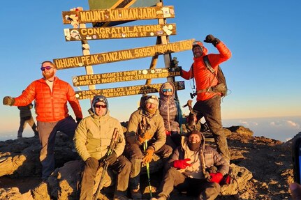 Retired Navy Master Chief (Center) at the top of Mount Kilimanjaro in August of 2023.