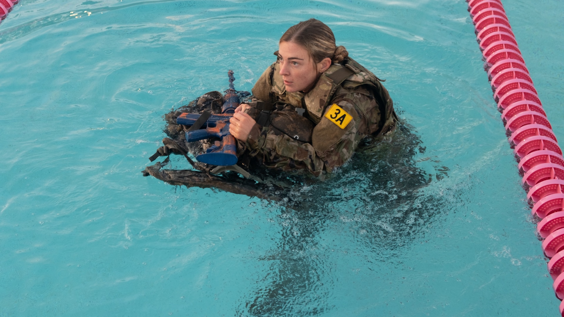 2nd. Lt. Madelyn Wojciechowski, representing Tripler Army Medical Center’s Alpha Company,  stays afloat during the combat water survival test event of the TAMC Best Leader Competition, held at Schofield Barracks, Hawaii on Jan. 27, 2025.