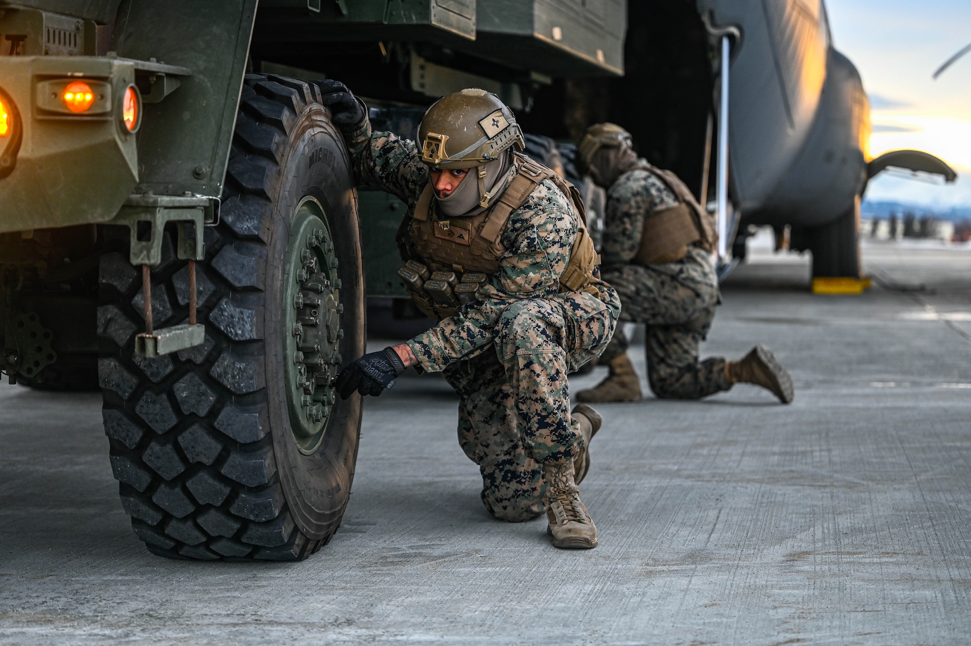 U.S. Marines, assigned to release air from the tires of a High Mobility Artillery Rocket System (HIMARS) vehicle, assigned to the 1st Battalion, 11th Field Artillery Regiment,  during the Joint Pacific Multinational Readiness Center (JPMRC) 25-02 exercise at Joint Base Elmendorf-Richardson, Alaska, Jan. 18, 2025. JPMRC 25-02 has participants from the Canadian and Mongolian Army, HIMARS from U.S. Marine Corps’ 1st Battalion, 11th Field Artillery Regiment, and Marine Air Control Squadron (MASS-6), supporting aircraft from across the U.S. Air Force, as well as other enablers from partner nations and across the U.S. Department of Defense.