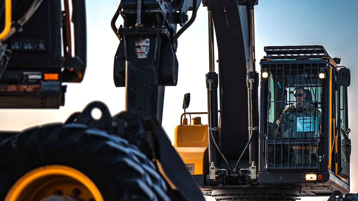 Airman operates excavator