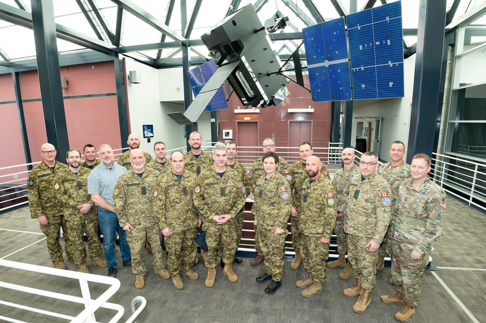 Royal Canadian Air Force Brigadier-General Kyle Paul, Space Operations Command (SpOC) Deputy Commander of Operations, Plans, Training, and Force Development (far left), and U.S. Space Force Chief Master Sgt. Caleb Lloyd, Space Operations Command Senior Enlisted Leader (second from right), welcome a group of Canadian Royal Air Force Command Chief Warrant Officers to SpOC Headquarters at Peterson Space Force Base, Colorado, Feb. 4. 2025.