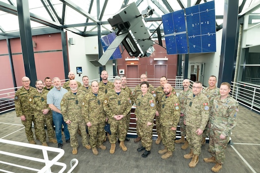  Royal Canadian Air Force Brigadier-General Kyle Paul, Space Operations Command (SpOC) Deputy Commander of Operations, Plans, Training, and Force Development (far left), and U.S. Space Force Chief Master Sgt. Caleb Lloyd, Space Operations Command Senior Enlisted Leader (second from right), welcome a group of Canadian Royal Air Force Command Chief Warrant Officers to SpOC Headquarters at Peterson Space Force Base, Colorado, Feb. 4. 2025.