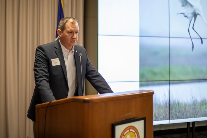 Person is standing at a podium while talking