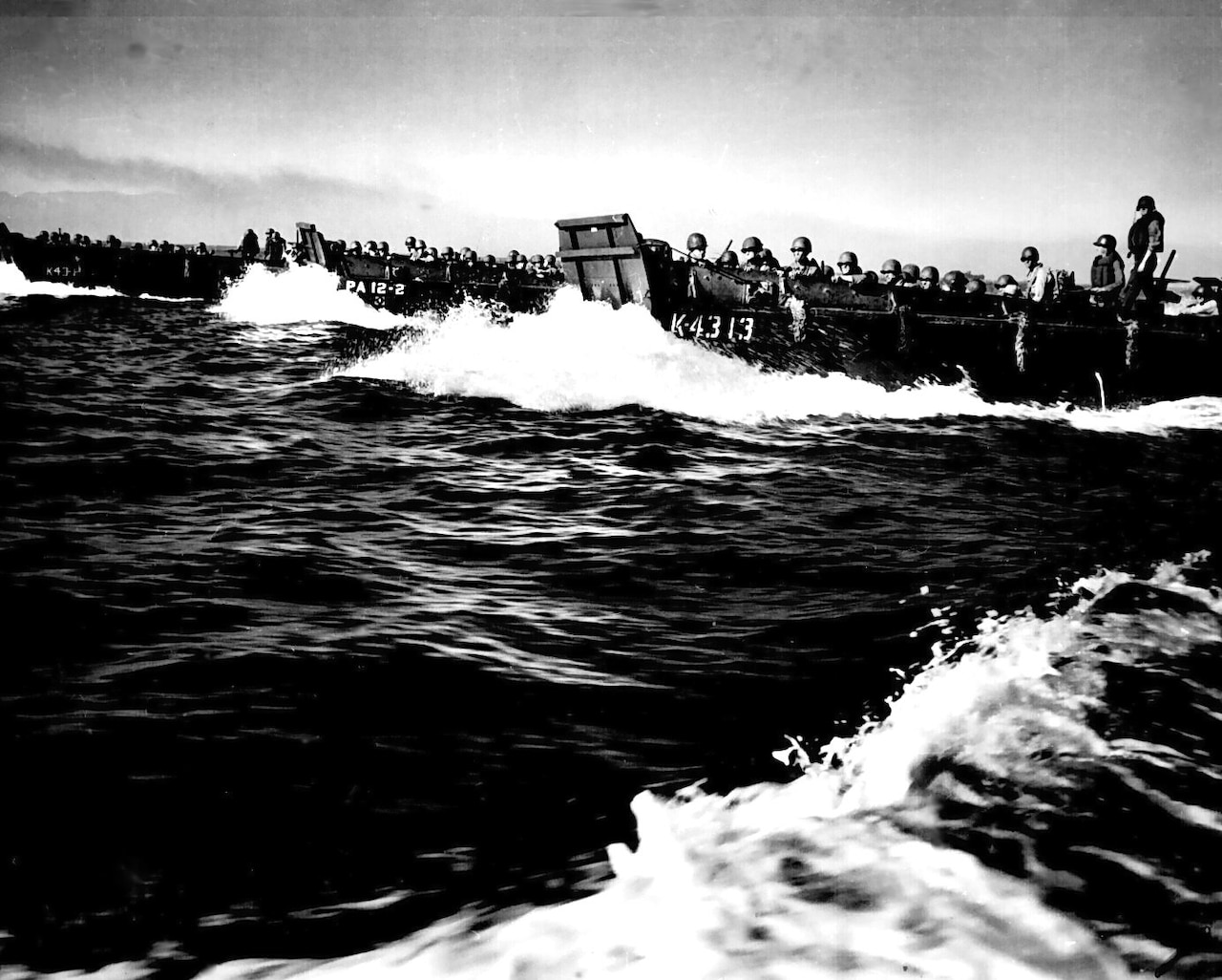 A landing craft with troops heading for the beach.