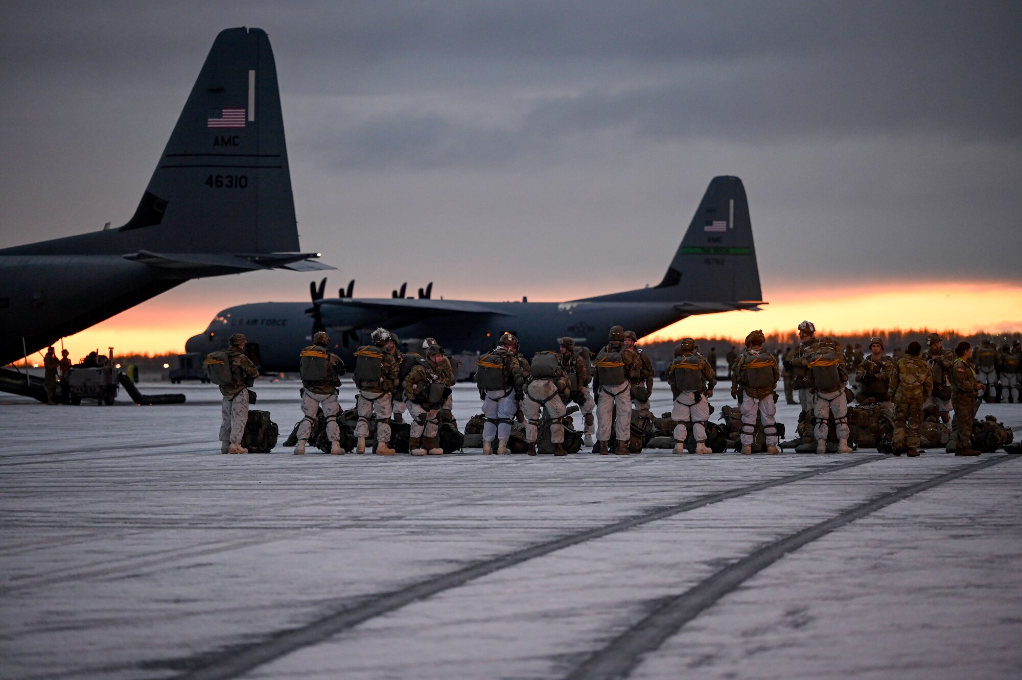 Paratroopers assigned to the 2nd Infantry Brigade Combat Team (Airborne), 11th Airborne Division, walk towards a C-130J Super Hercules aircraft prior to a Joint Forcible Entry (JFE) to kick off the Joint Pacific Multinational Readiness Center 25-02 exercise at Joint Base Elmendorf-Richardson, Alaska, Jan. 22, 2025. JPMRC 25-02, executed in Alaska with its world-class training facilities and its harsh Arctic environment, built our military members and leaders into a cohesive team of skilled, tough, alert, and adaptive warriors capable of fighting and winning anywhere in the world.