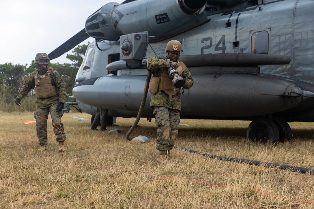 U.S. Marines with Marine Wing Support Squadron 172, Marine Aircraft Group 36, 1st Marine Aircraft Wing return from fueling a CH-53E Super Stallion helicopter on a forward arming and refueling point during Nansei Sword 25 at Central Training Area, Okinawa, Japan, Feb. 5, 2025. Nansei Sword 25 is designed to provide realistic training that increases the combat readiness of MAG-36 through exercising communication setup and utilization and providing logistical support throughout dispersed locations. (U.S. Marine Corps photo by Lance Cpl. Jeremiah Barksdale)