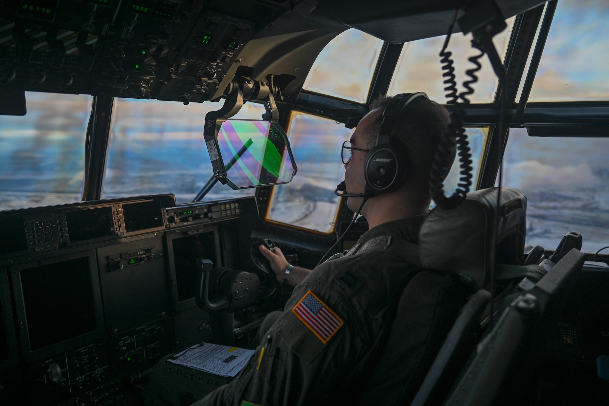 Capt. Jack Hartge, 61st Airlift Squadron pilot, flies over Alaska during the Joint Pacific Multinational Readiness Center (JPMRC) 25-02 exercise at Joint Base Elmendorf-Richardson, Alaska, Jan. 19, 2025. Exercises such as JPMRC increase our ability to work together across the military spectrum to respond to crises, support the local population and accomplish the mission.