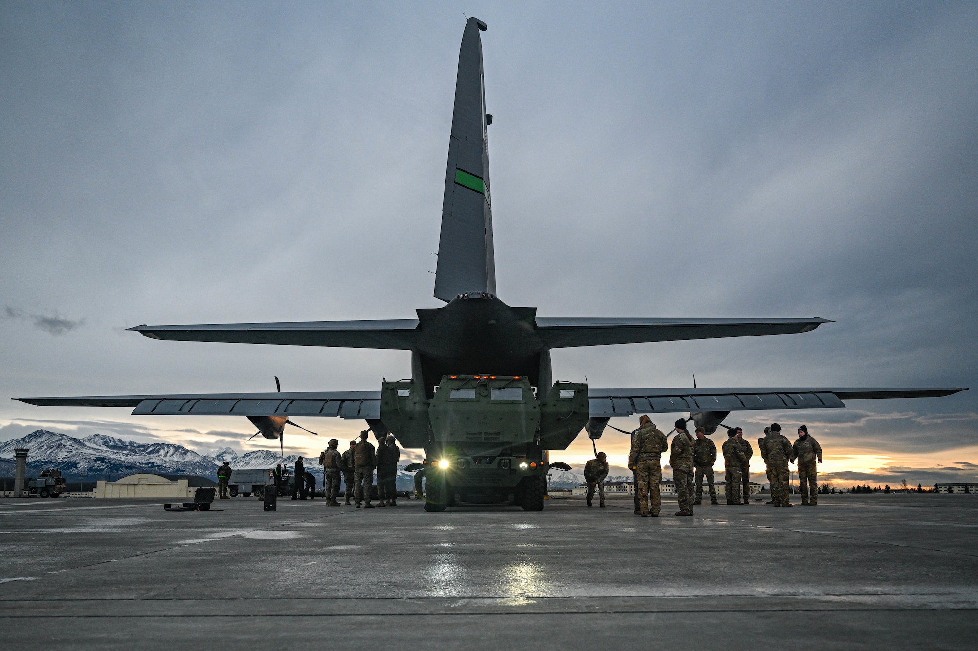 A High Mobility Artillery Rocket System (HIMARS) vehicle, assigned to the 1st Battalion, 11th Field Artillery Regiment, is marshaled onto a C-130J Super Hercules aircraft during the Joint Pacific Multinational Readiness Center (JPMRC) 25-02 exercise at Joint Base Elmendorf-Richardson, Alaska, Jan. 18, 2025. Conducting HIMARS training showcases the 19th Airlift Wing crew’s combat readiness and quick-precision-striking ability by rapidly onloading, offloading and mobilizing the HIMARS.