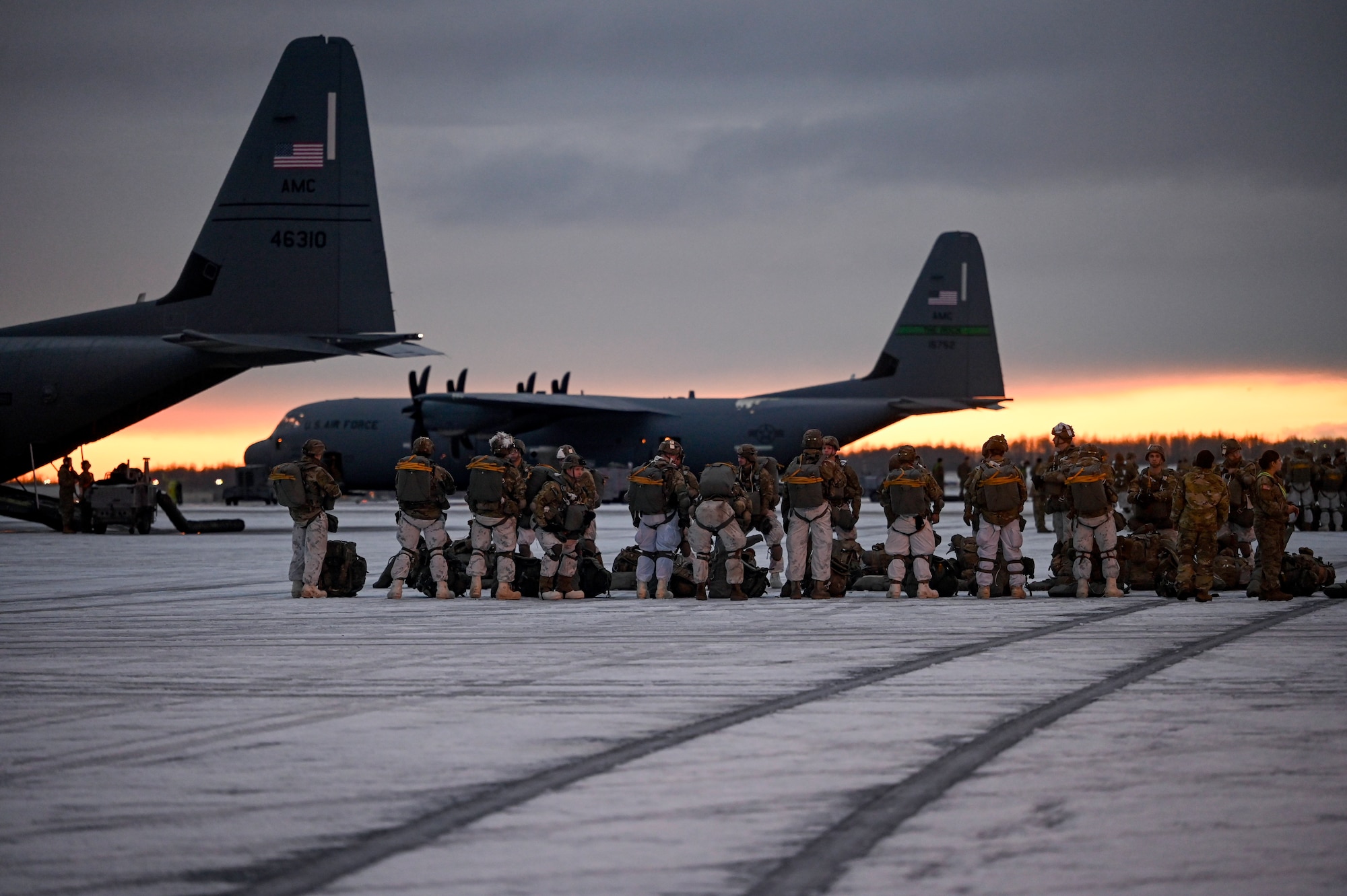 Paratroopers assigned to the 2nd Infantry Brigade Combat Team (Airborne), 11th Airborne Division, walk towards a C-130J Super Hercules aircraft prior to a Joint Forcible Entry (JFE) to kick off the Joint Pacific Multinational Readiness Center 25-02 exercise at Joint Base Elmendorf-Richardson, Alaska, Jan. 22, 2025. JPMRC 25-02, executed in Alaska with its world-class training facilities and its harsh Arctic environment, built our military members and leaders into a cohesive team of skilled, tough, alert, and adaptive warriors capable of fighting and winning anywhere in the world.