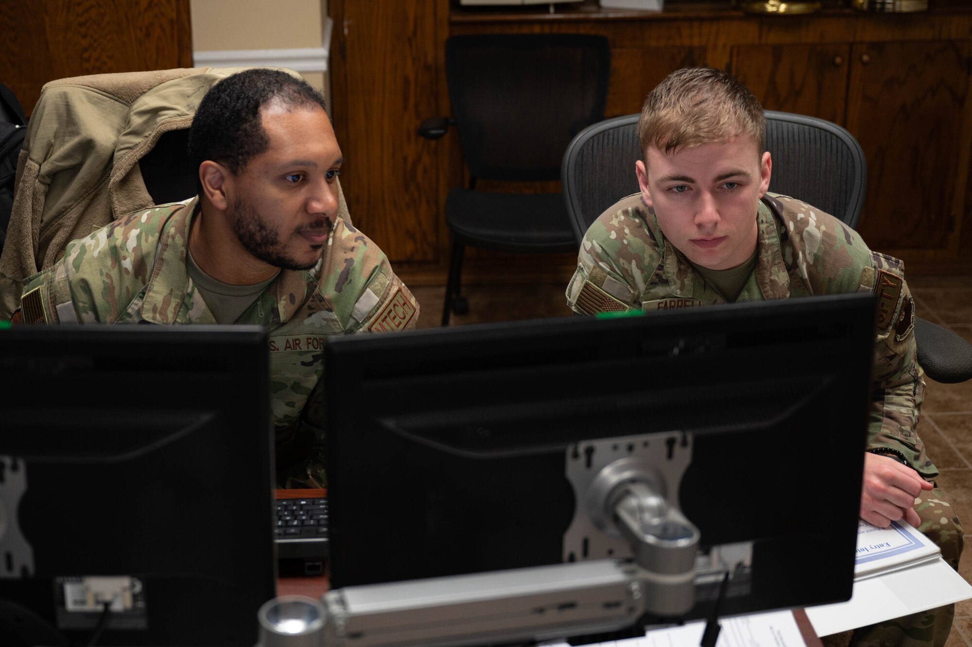U.S. Air Force Tech. Sgt. William Huff, 2nd Maintenance Squadron aircraft metals technology noncommissioned officer in charge, goes through his shop’s safety programs with Senior Airman William Farrell, 2nd Bomb Wing Safety Office safety apprentice at Barksdale Air Force Base, La., Dec. 9, 2024.