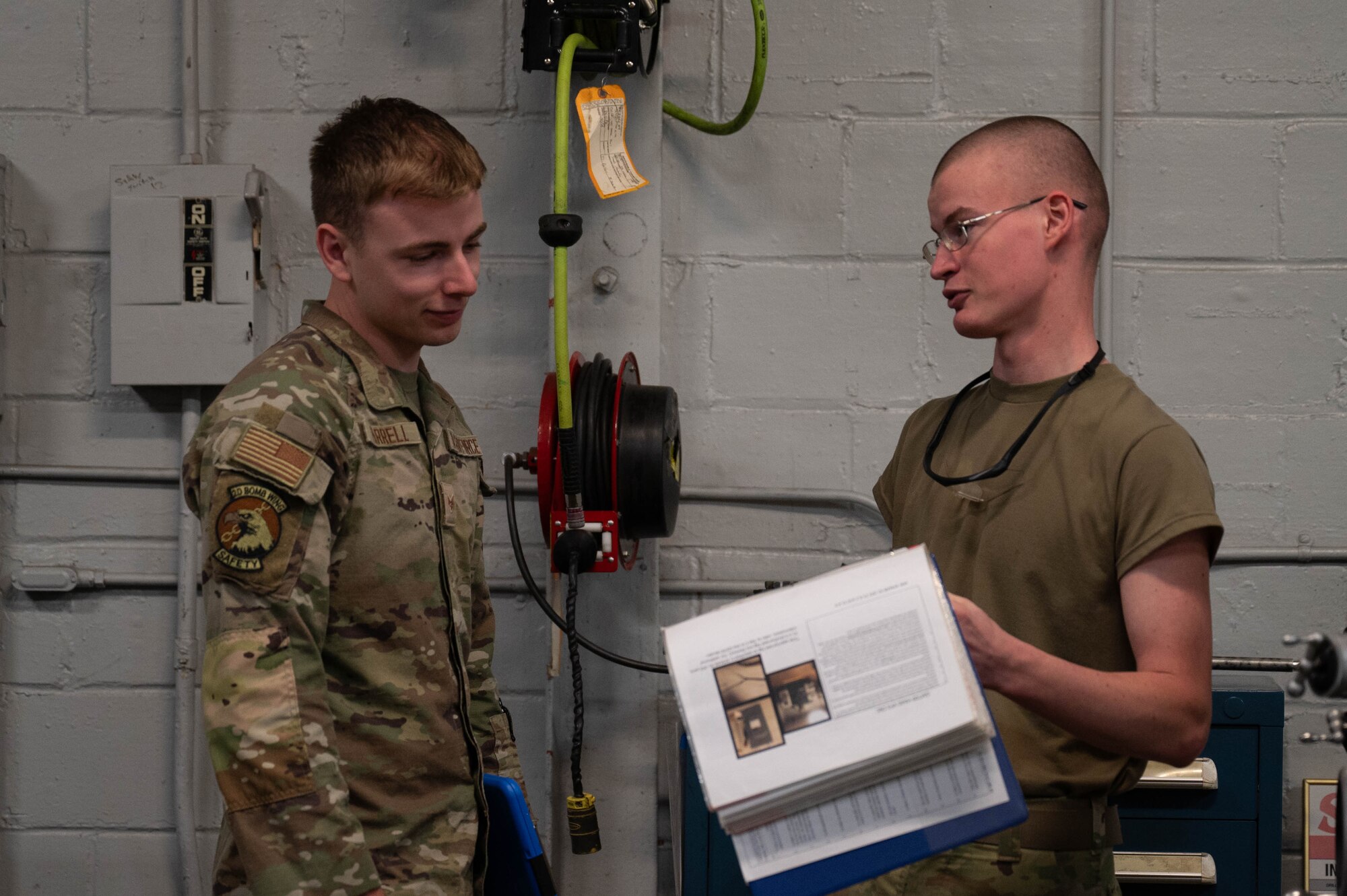 U.S. Air Force Tech. Sgt. Donovan Evans, 2nd Bomb Wing Safety installation safety noncommissioned officer in charge, walks through the aircraft metals technology shop with Airman 1st Class Chistopher Brewer, 2nd Maintenance Squadron aircraft metals technology journeyman at Barksdale Air Force Base, La., Dec. 9, 2024.