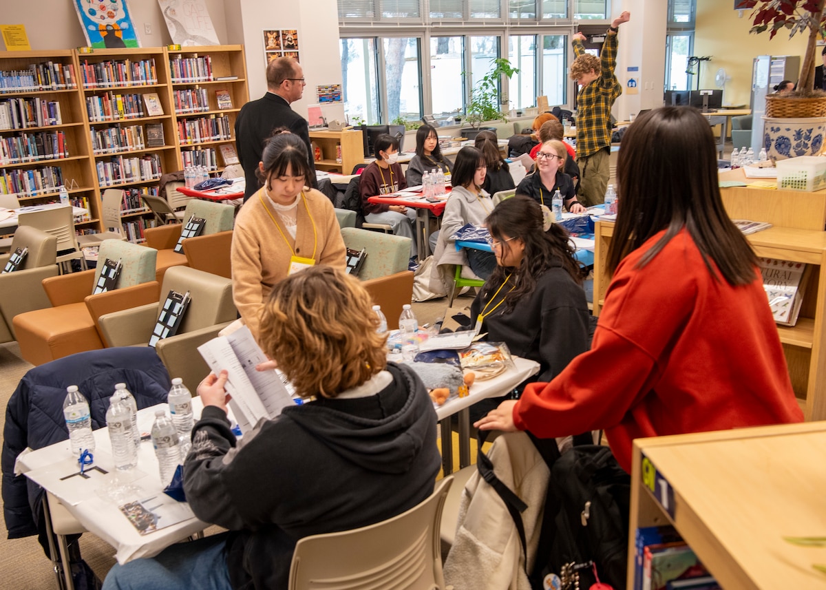 Students from Edgren Middle-High School and local Japanese high schools interact after finishing their group projects during a Student Educational Exchange and Dialogue (SEED) project at Misawa Air Base, Japan, Feb. 2, 2025.