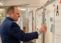 U.S. Air Force Col. Matthew Kenkel, 35th Fighter Wing deputy commander, places feedback notes on a group project during a Student Educational Exchange and Dialogue (SEED) project at Misawa Air Base, Japan, Feb. 2, 2025.