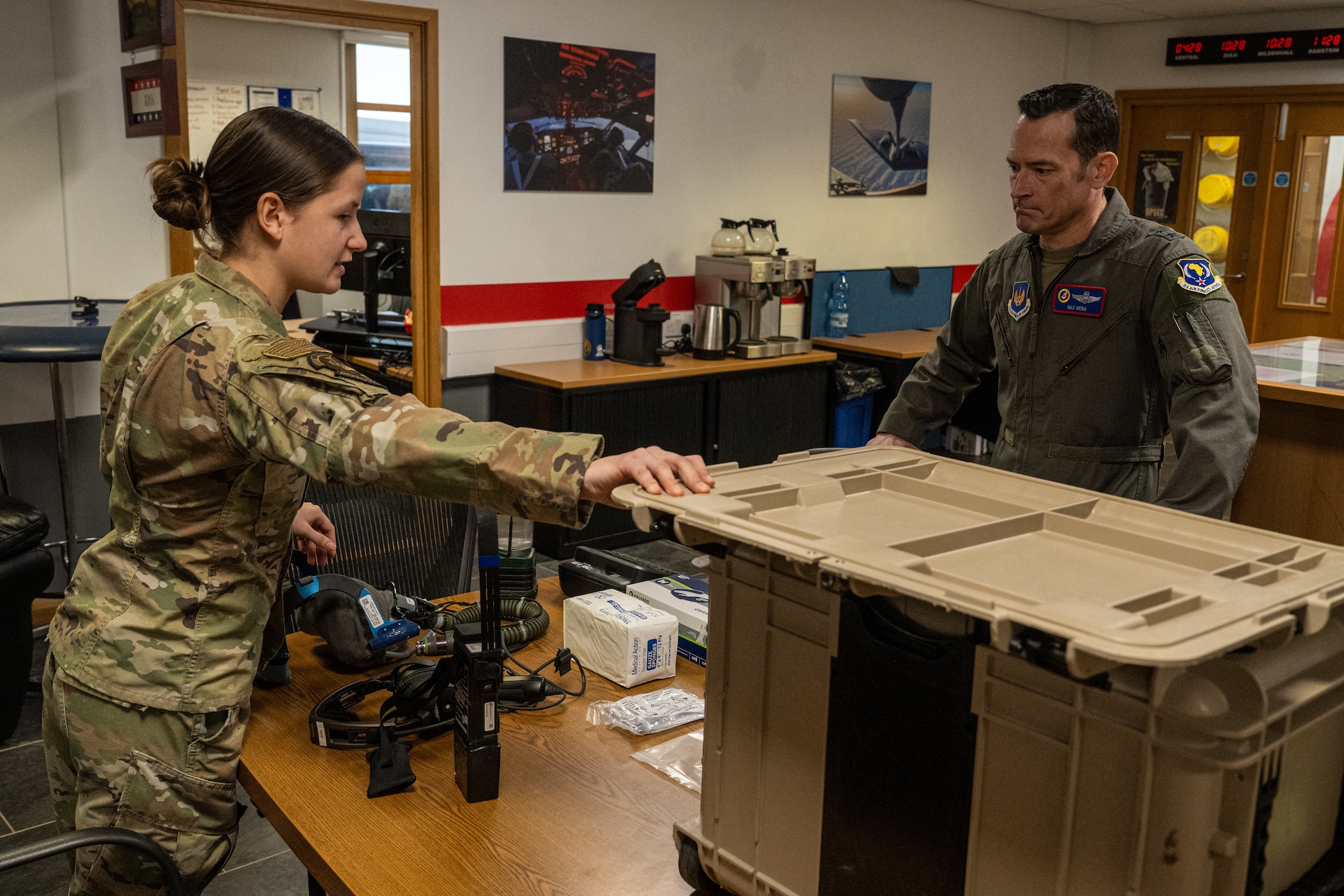 U.S. Air Force Maj. Gen. Paul Moga, right, Third Air Force commander, receives a brief from Senior Airman Annabelle Cadd, 100th Operations Support Squadron aircrew flight equipment technician, at RAF Mildenhall, England, Jan. 30, 2025. Moga was briefed by Cadd about how the 100th OSS can support agile combat employment concepts at forward operating bases. (U.S. Air Force photo by Senior Airman Christopher Campbell)