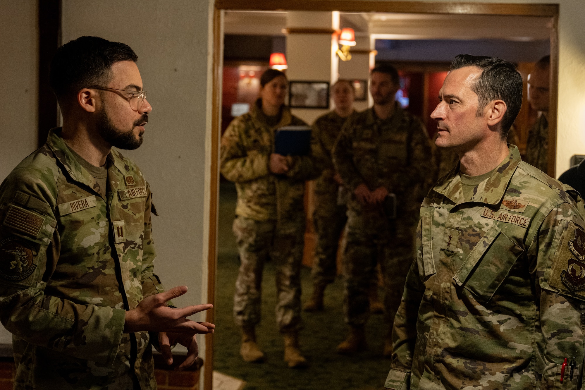 U.S. Air Force Maj. Gen. Paul Moga, right, Third Air Force commander, receives a brief from Capt. Carlos Rivera, 100th Force Support Squadron flight commander, at RAF Mildenhall, England, Jan. 28, 2025. Moga met with Airmen, observed ongoing operations, and gained a better understanding of the challenges and successes of the 100th Air Refueling Wing and its tenant unit’s mission. (U.S. Air Force photo by Senior Airman Christopher Campbell)