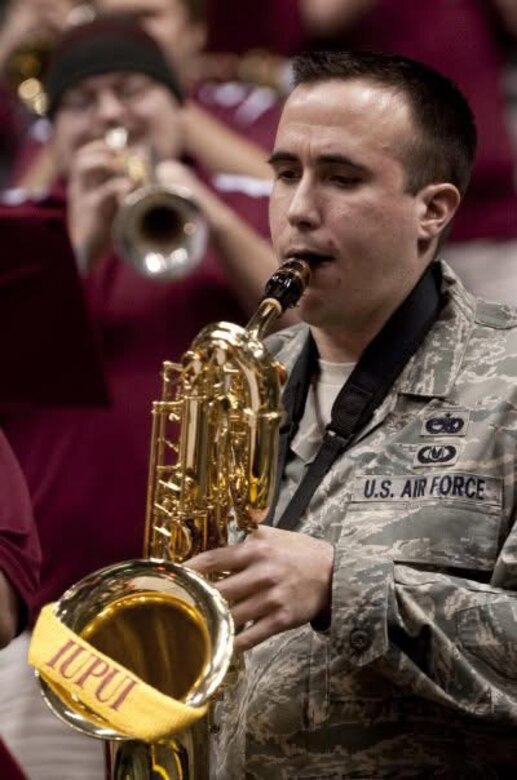 Aaron Widner performs as a member of the Air Force pep band during Military Night at an IUPUI men’s basketball game at Banker’s Life Fieldhouse in Indianapolis, Indiana, in 2009.