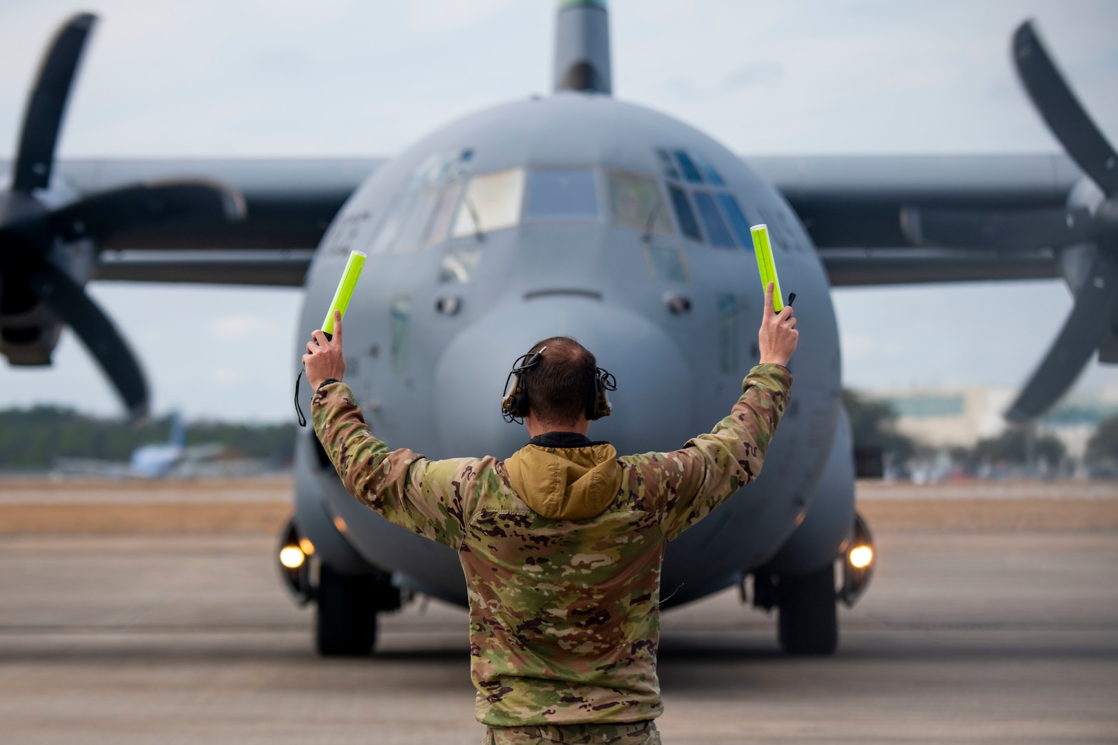 A U.S. Air Force Airman assigned to the 146th Airlift Wing marshals a C-130H Hercules at the Combat Readiness and Training Center, Gulfport, Mississippi, Feb. 5, 2025. Exercise Sentry South-Southern Strike is a joint military training focusing on contingency response operations, agile combat employment, aeromedical evacuation, maritime training, specialized fueling operations and strategic airlift and airdrops.