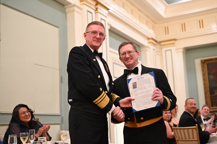 WASHINGTON - Vice Adm. Johnny R. Wolfe, Jr, director of Strategic Systems Programs (SSP) (left) thanks and Cdr. Robert Blanchard, branch head for Fire Control and Guidance Branch (right) for his dedication to his role as Mr. Vice during SSP’s Dining Out on 1 Feb. “Shenanigans”, such as pranks, songs, and good-natured jokes, camaraderie, and an appreciation for Navy heritage, were on full display the event, held at the Army and Navy Club in Washington, D.C. 



2025, marks the Navy’s 250th birthday. For 250 years, the Navy’s sailors and civilians have been the key ingredient to U.S. maritime dominance, providing an unmatched advantage at sea and onshore. Navy traditions such as Dining Outs, are an important part of connecting today’s sailors and civilians with the rich history of generations that served before them and provide an opportunity to pass down that heritage to the younger generations within the ranks. (U.S. Navy photo by Lt. Gustavo Villanueva/Released)