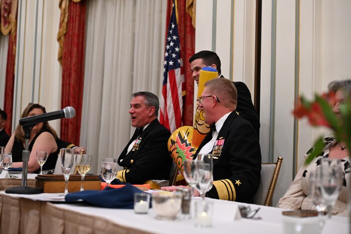 WASHINGTON – Guest of Honor Rear Adm. Douglas Williams, director for test for the Missile Defense Agency (left) and “President of the Mess,” Vice Adm. Johnny R. Wolfe, Jr, director of Strategic Systems Programs (SSP) (right) laugh as Lt. Andrew Swartz, deputy section head for Launcher Operations Section, presents Williams with an inflatable hammer during SSP’s Dining Out on 1 Feb. “Shenanigans”, such as pranks, songs, and good-natured jokes, camaraderie, and an appreciation for Navy heritage, were on full display the event, held at the Army and Navy Club in Washington, D.C. 



2025, marks the Navy’s 250th birthday. For 250 years, the Navy’s sailors and civilians have been the key ingredient to U.S. maritime dominance, providing an unmatched advantage at sea and onshore. Navy traditions such as Dining Outs, are an important part of connecting today’s sailors and civilians with the rich history of generations that served before them and provide an opportunity to pass down that heritage to the younger generations within the ranks. (U.S. Navy photo by Lt. Gustavo Villanueva/Released)