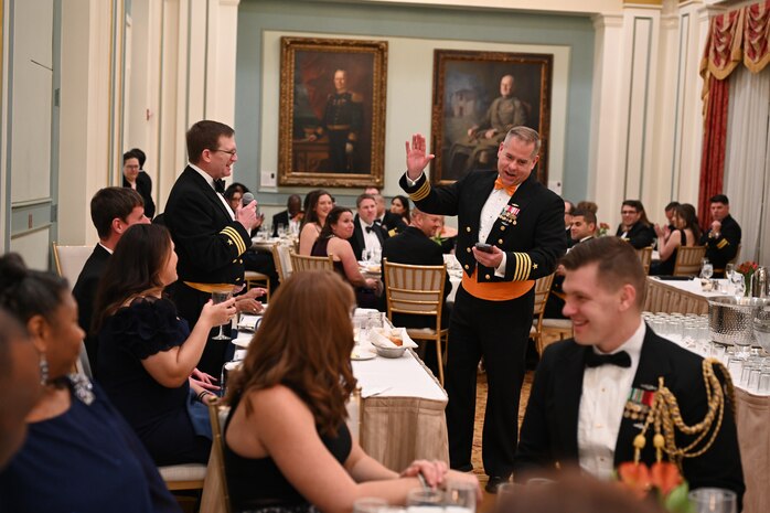 WASHINGTON - Cdr. Robert Blanchard, branch head for Fire Control and Guidance Branch at Strategic Systems Programs (SSP) (left) in his role as Mr. Vice, orders Capt. Charles ‘Chas’ McLenithan, chief of staff (right) to partake of the ‘grog’ at SSP’s Dining Out on 1 Feb. ‘Grog’ is traditionally a mixture of fruit punch and spirits that is also provided in a non-alcoholic version at present-day Dining Outs. The event, held at the Army Navy Club in Washington, D.C., fostered camaraderie and an appreciation for Navy heritage. 



2025, marks the Navy’s 250th birthday. For 250 years, the Navy’s sailors and civilians have been the key ingredient to U.S. maritime dominance, providing an unmatched advantage at sea and onshore. Navy traditions such as Dining Outs, are an important part of connecting today’s sailors and civilians with the rich history of generations that served before them and provide an opportunity to pass down that heritage to the younger generations within the ranks. (U.S. Navy photo by Lt. Gustavo Villanueva/Released)