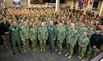 Rear Adm. Kenneth Blackmon, center, vice commander of U.S. Fleet Forces, poses for a photo with Navy Reserve Sailors at the Navy Warfare Development Center in Norfolk, Virginia, for MAKO Challenge 2025.