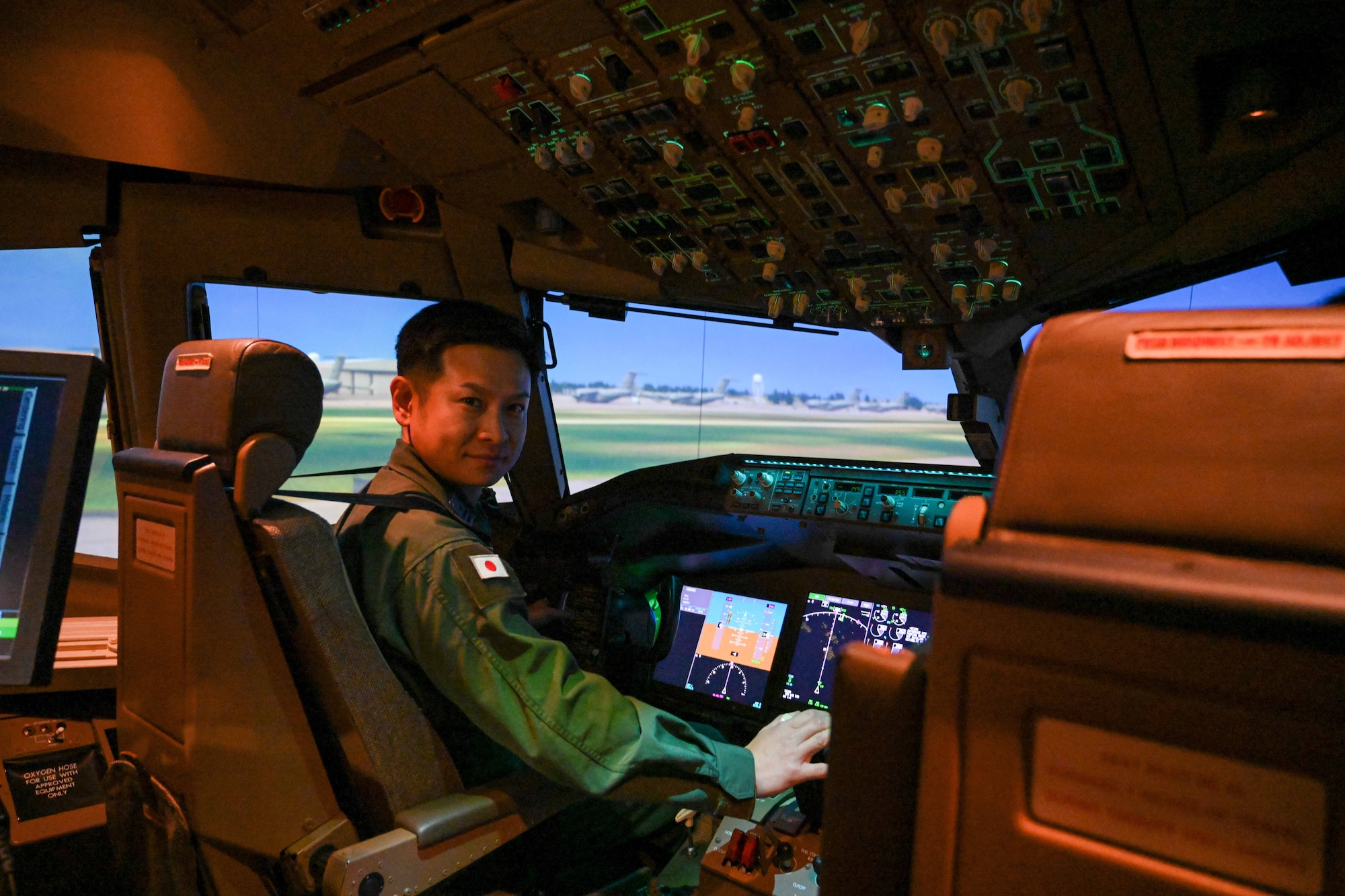 Japanese Air Self-Defense Force Maj. Yohei Uramoto, 405th Air Refueling Squadron KC-46 Pegasus aircraft pilot, poses for a photo in a KC-46 simulator at Altus Air Force Base, Oklahoma, Nov. 6, 2024. Uramoto participated in a refresher course with the 97th Air Mobility Wing to reinforce and assess his knowledge of the aircraft. (U.S. Air Force photo by Airman 1st Class Lauren Torres)