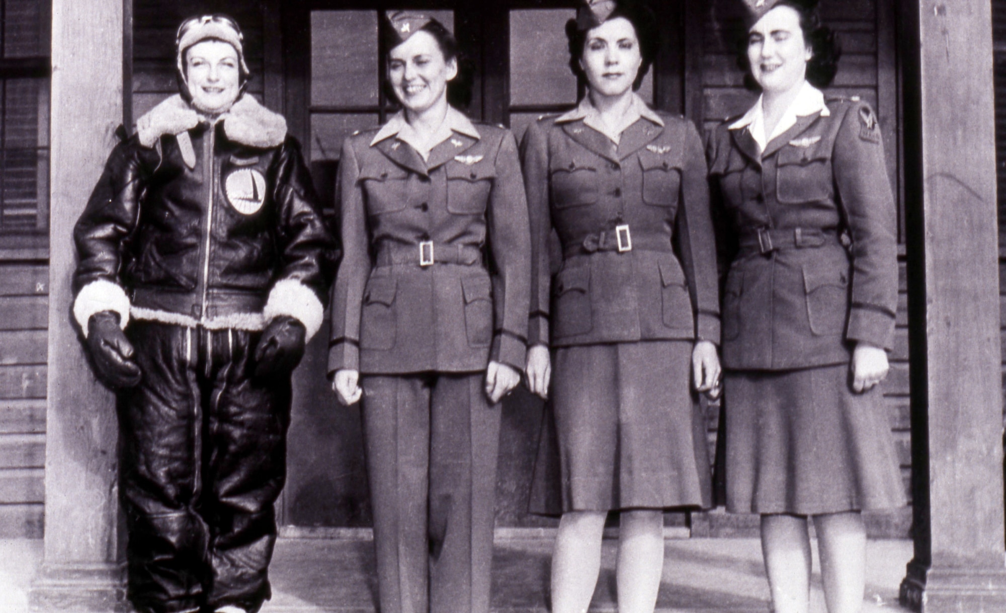 Four “Originals” modeling WAFS uniforms. Left to Right: Barbara Poole in winter flying gear, Evelyn Sharp in a flying uniform, Esther Manning in a duty uniform, and Barbara Erickson in a dress uniform.