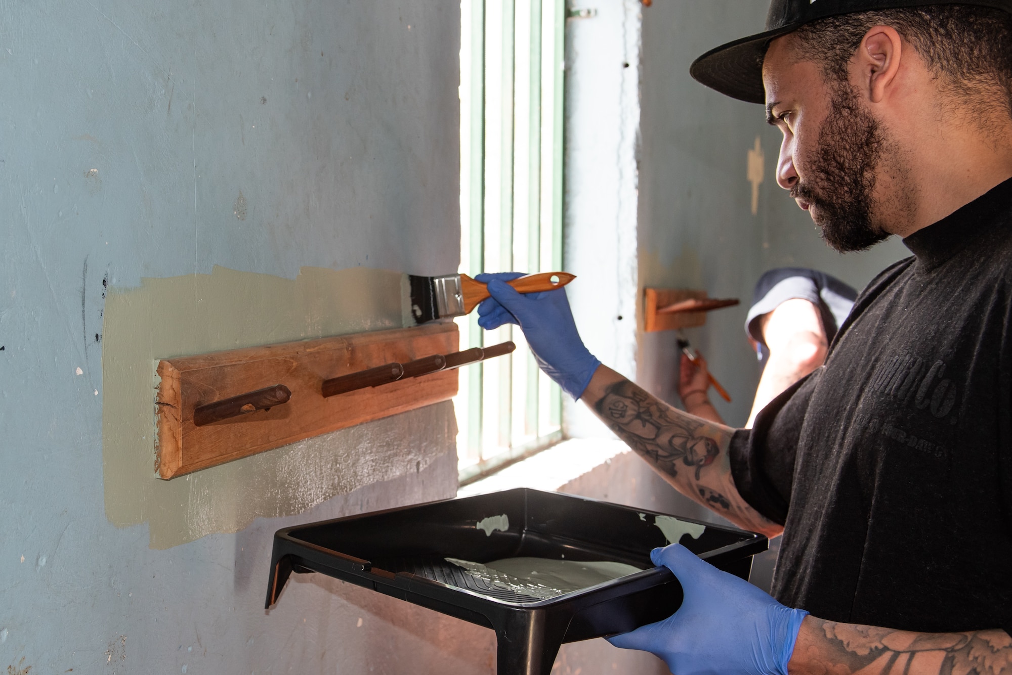 A Joint Task Force-Bravo member paints a wall at San Antonio de Padua orphanage in Comayagua, Honduras, January 25, 2025.
