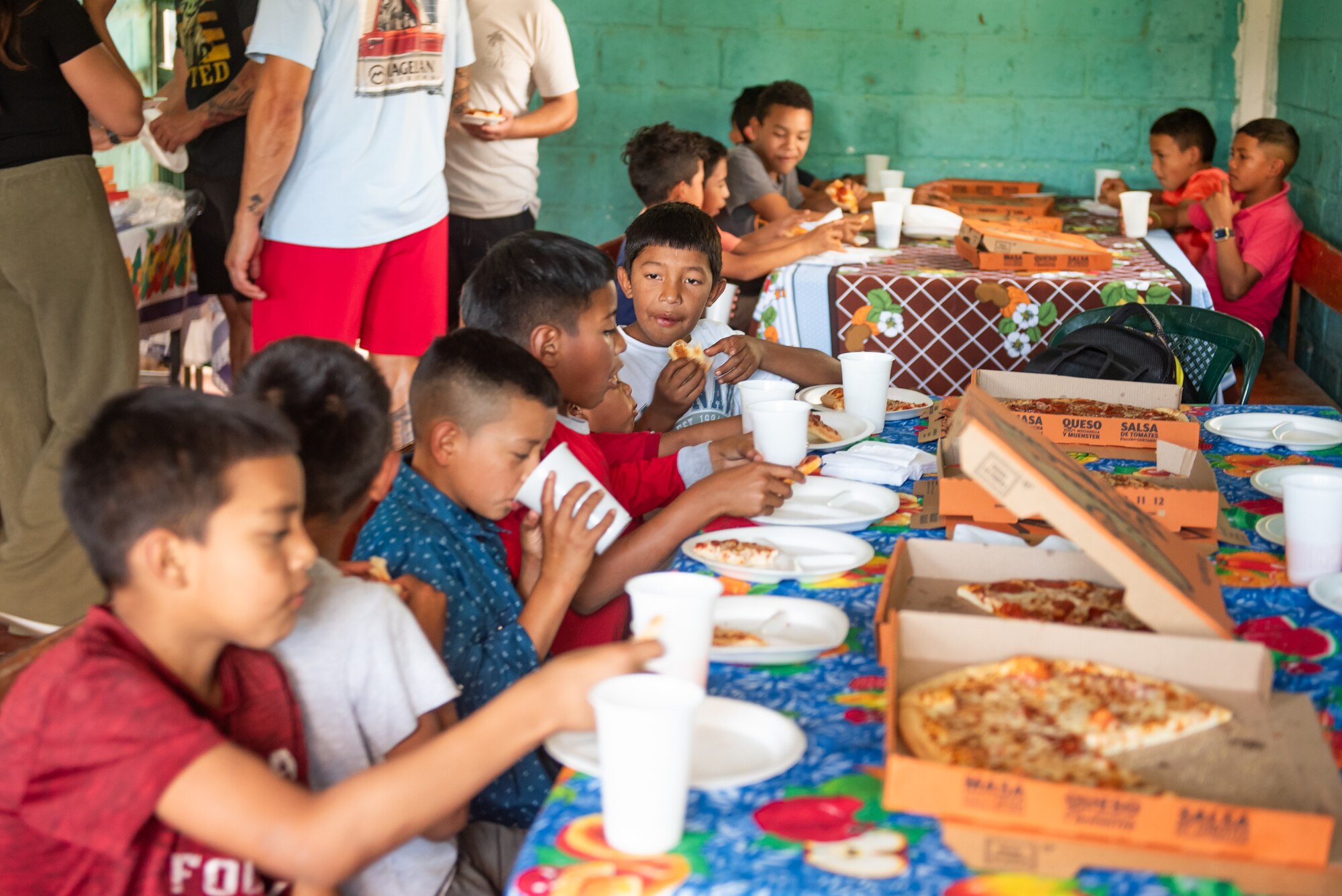 Children from San Antonio de Padua orphanage eat pizza at the orphanage in Comayagua, Honduras, January 27, 2025.