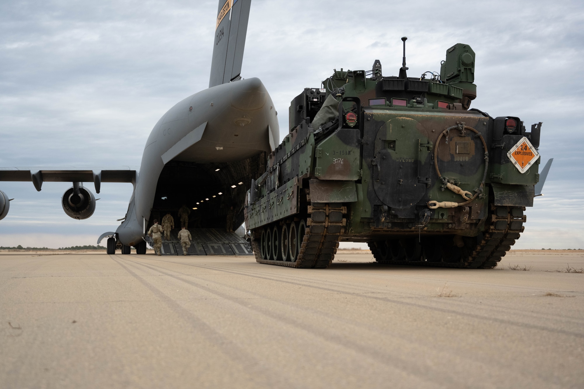 A Bradly Fighting Vehicle is offloaded from an aircraft.