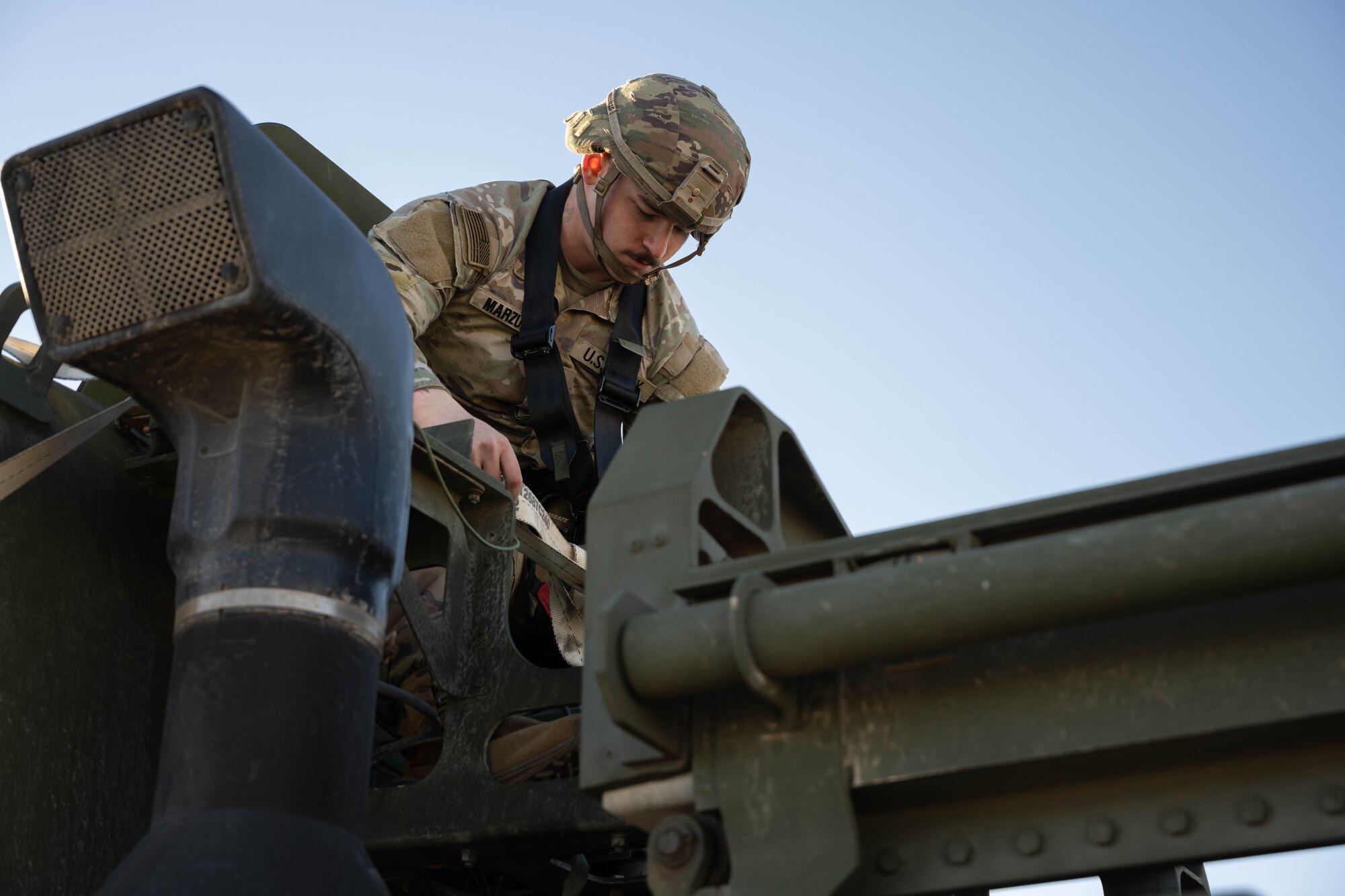 A U.S Soldier preps a HIMAR for loading.