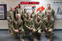 A group of uniformed personnel stand together for a photo.