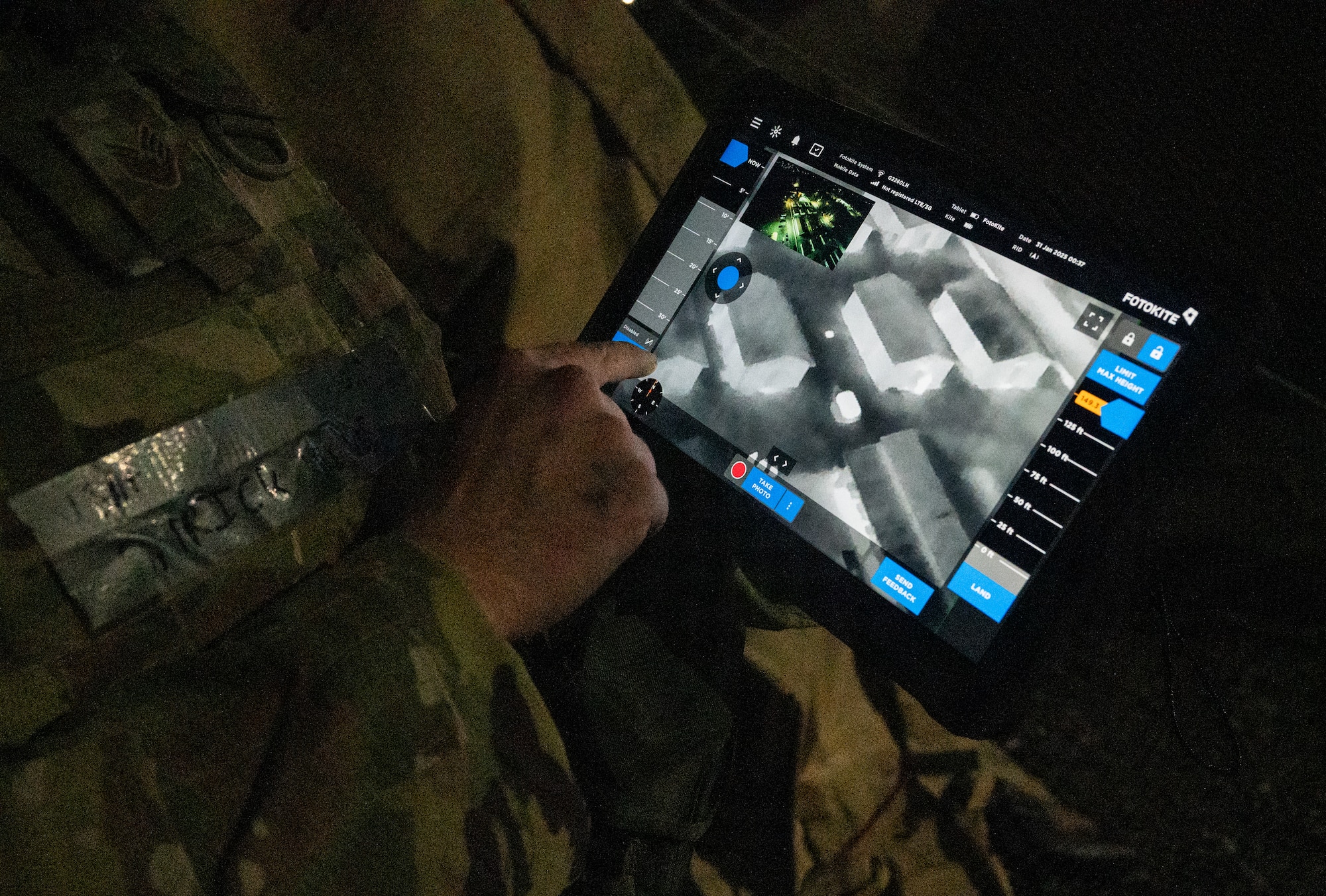 finger points at night vision screen