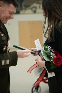 Rebecca Riley is pinned with the honorable rank of Colonel by her husband Col. Shane Riley for her support throughout his career during his retirement ceremony held at the Norman Armed Forces Reserve Center in Norman, Oklahoma on Feb. 1, 2025.  Riley is a highly decorated infantry officer, having served 36 years with various roles in support of domestic response and combat deployments abroad.  (Oklahoma National Guard Photo by Spc. Cambrie Cannon)