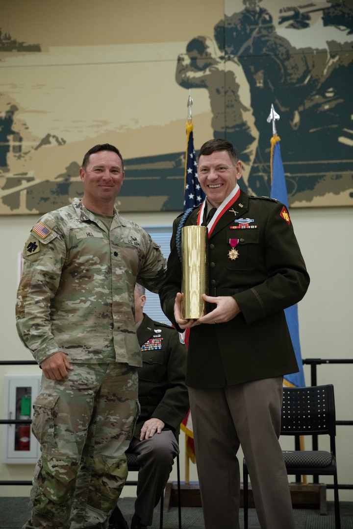 Col. Shane Riley receives an engraved artillery casing from Lt. Col. Brent Hill, commander for the 1st Battalion, 160th Field Artillery Regiment during his retirement ceremony held at the Norman Armed Forces Reserve Center in Norman, Oklahoma, Feb. 1, 2025. Riley is a highly decorated infantry Officer, having served 36 years with various roles in support of domestic response and combat deployments abroad.  (Oklahoma National Guard Photo by Spc. Cambrie Cannon)