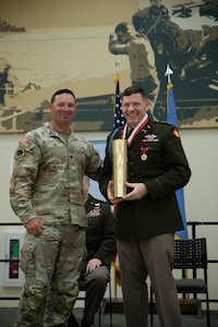 Col. Shane Riley receives an engraved artillery casing from Lt. Col. Brent Hill, commander for the 1st Battalion, 160th Field Artillery Regiment during his retirement ceremony held at the Norman Armed Forces Reserve Center in Norman, Oklahoma, Feb. 1, 2025. Riley is a highly decorated infantry Officer, having served 36 years with various roles in support of domestic response and combat deployments abroad.  (Oklahoma National Guard Photo by Spc. Cambrie Cannon)