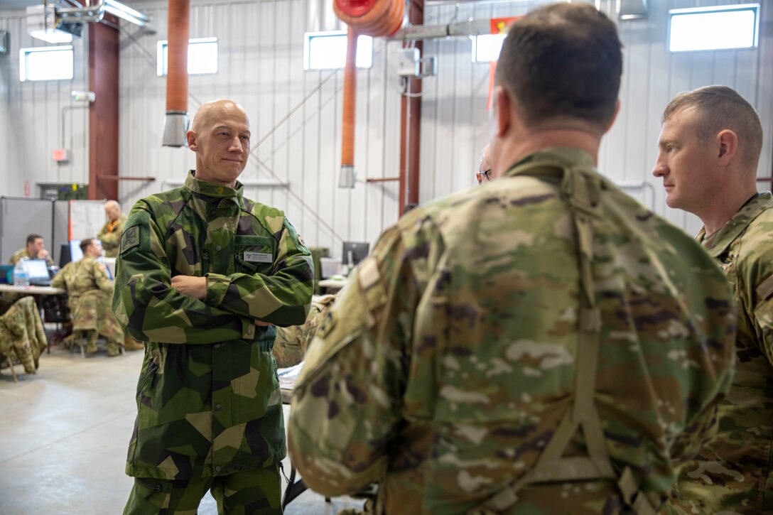 FORT INDIANTOWN GAP, Pa. – Swedish Army Lt. Col. Fredrik Mansson, the chief of operations for the 1st Division Headquarters, speaks with U.S. Army senior leaders from the New York National Guard’s 42nd Infantry Division during the division’s Warfighter 25-3 exercise at Fort Indiantown Gap, Pa., Feb. 3, 2025.