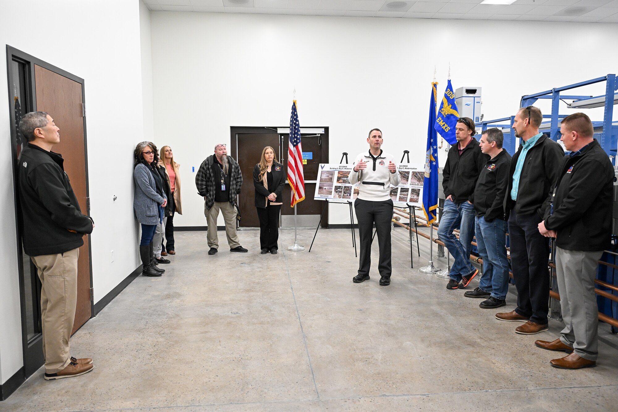Workers from the 309th Electronics Maintenance Group recently gathered for a ribbon cutting ceremony to celebrate the opening of Building 5’s Bay E, which recently underwent dramatic renovations and modernization.