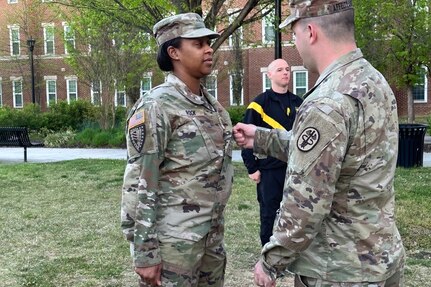 Alissa Rock is promoted to Sergeant at Fort Belvoir by Sgt. 1st Class Mark Affeltranger.