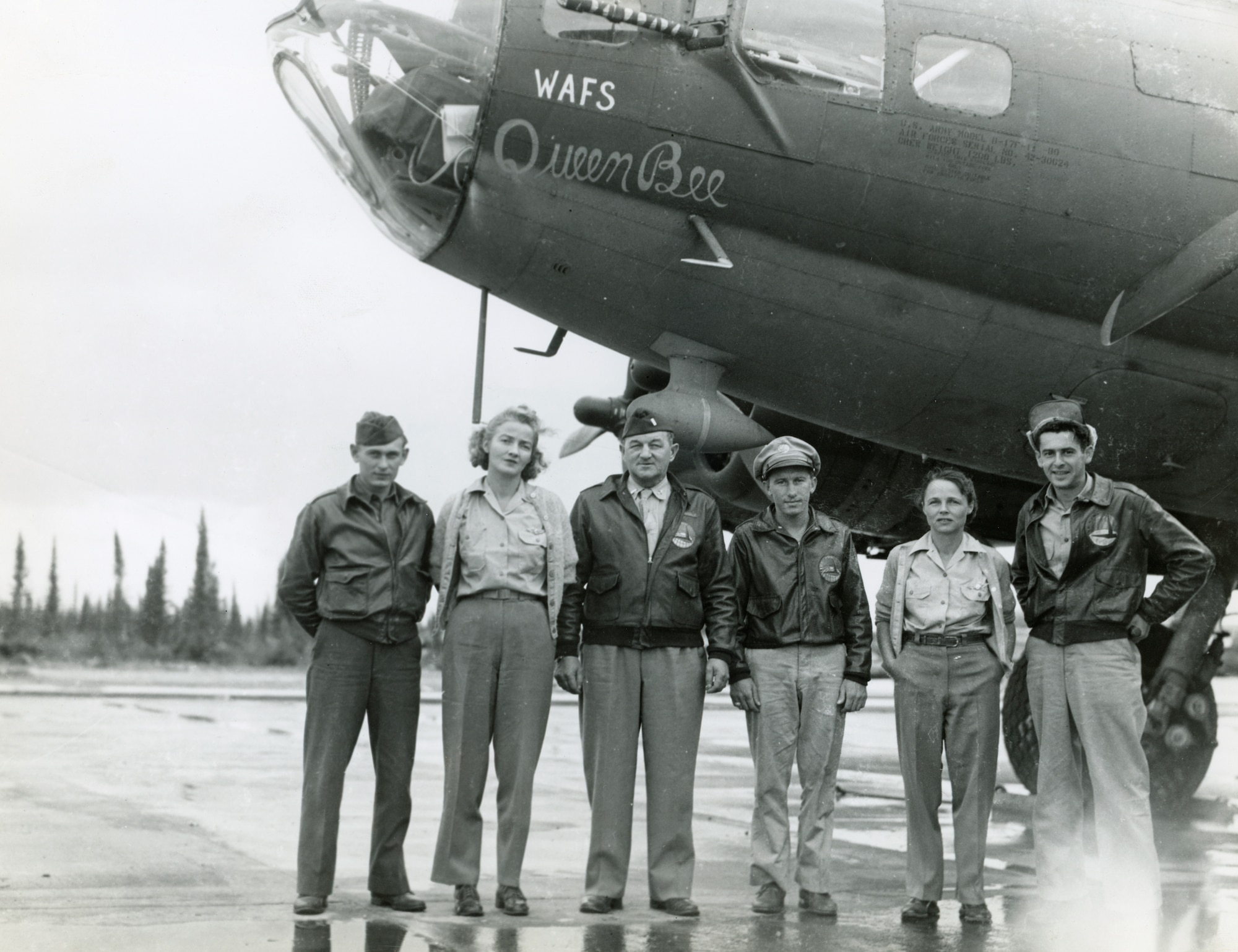 Love and Gillies and their crew standing in a row facing the camera in front of their aircraft