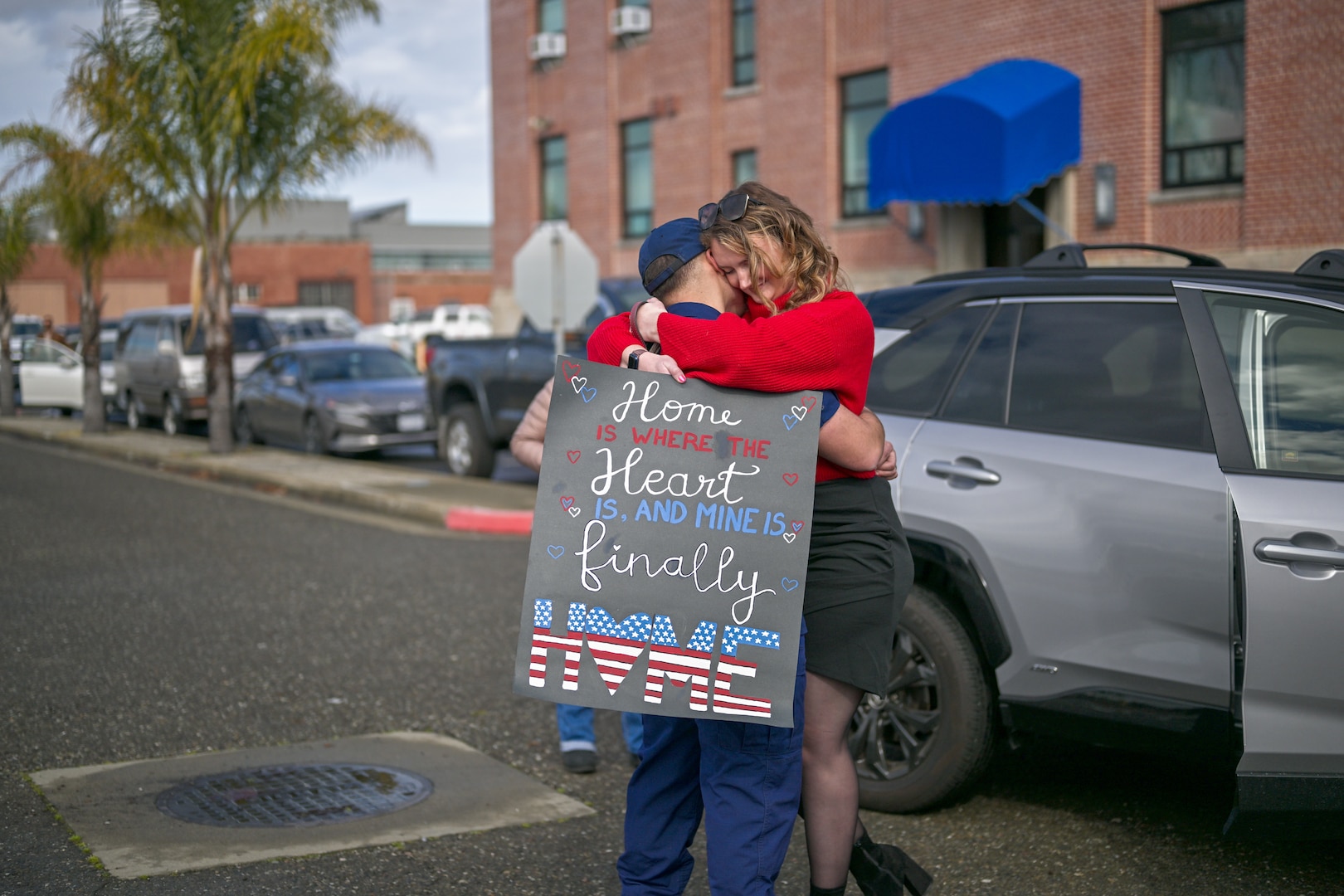 Lt. j.g. grade Christian Acevedo and his significant other embrace following the arrival of United States Coast Guard Cutter Bertholf (WMSL 750) to its home port in Alameda, California, Feb. 7, 2025. During the patrol, Bertholf’s crew promoted maritime governance, enforced domestic fishery regulations, and strengthened U.S. presence along the maritime boundary line. (U.S. Coast Guard photo by Petty Officer 3rd Class Austin Wiley.)