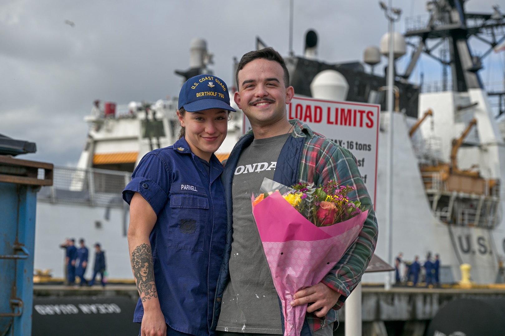 Petty Officer Second Class Mikayla Parnell poses for a photo with her significant other, following United States Coast Guard Cutter Bertholf’s (WMSL 750) return to home port in Alameda, California, Feb. 7, 2025. National security cutters like the Bertholf can hold up to 170 crewmembers, and Bertholf was the Coast Guard’s first Legend class national security cutter. (U.S. Coast Guard photo by Petty Officer 3rd Class Austin Wiley.)