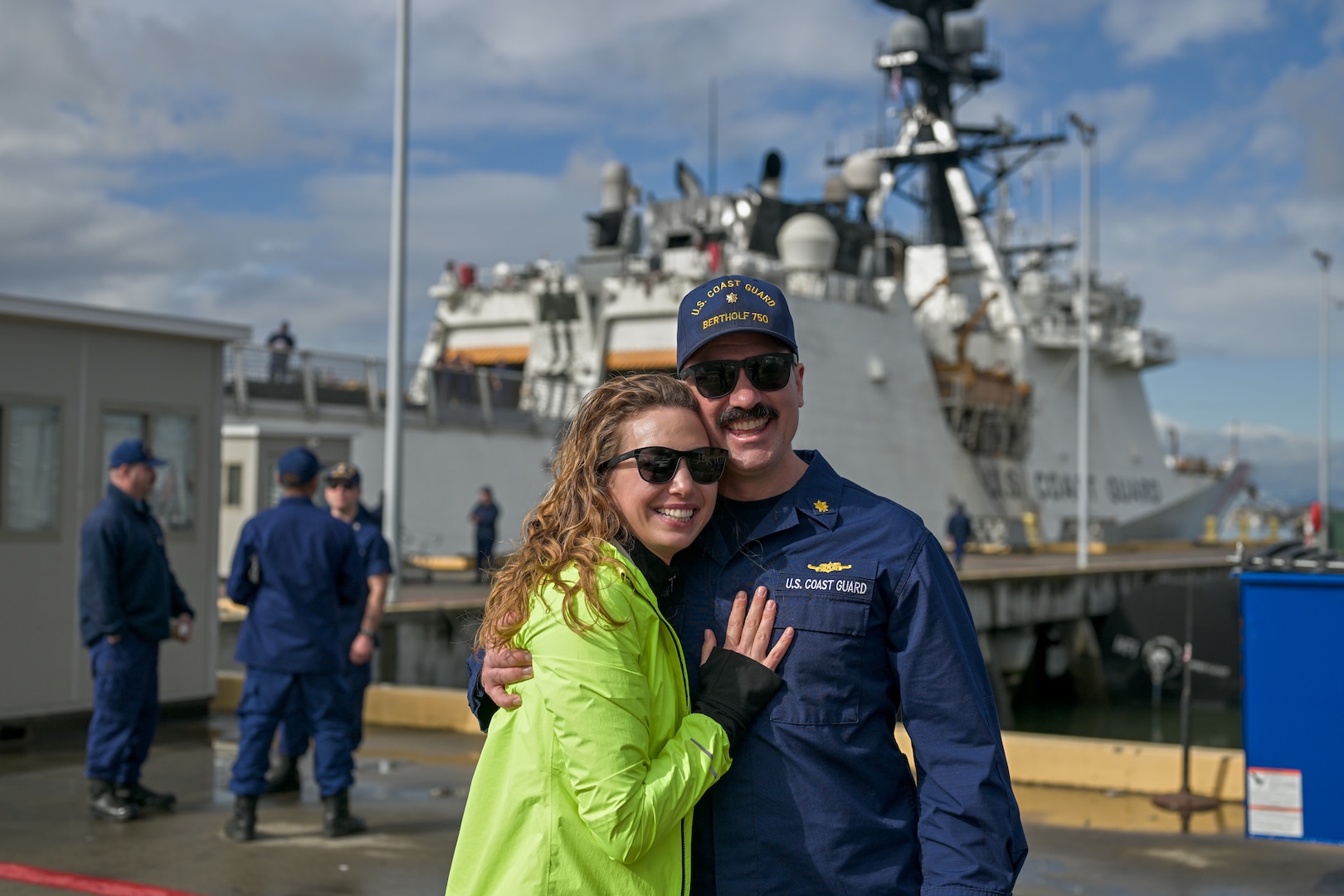 A United States Coast Guard Cutter Bertholf (WMSL 750) crewmember and his significant other embrace after arriving  home to Alameda, California, following Bertholf’s 130-day deployment, Feb. 7, 2025. The Bertholf’s crew showcased how the U.S. Coast Guard is a unique instrument of national power that bridges the divide between defense, diplomacy, and law enforcement and creates opportunities to further national objectives and priorities. (U.S. Coast Guard photo by Petty Officer 3rd Class Austin Wiley.)