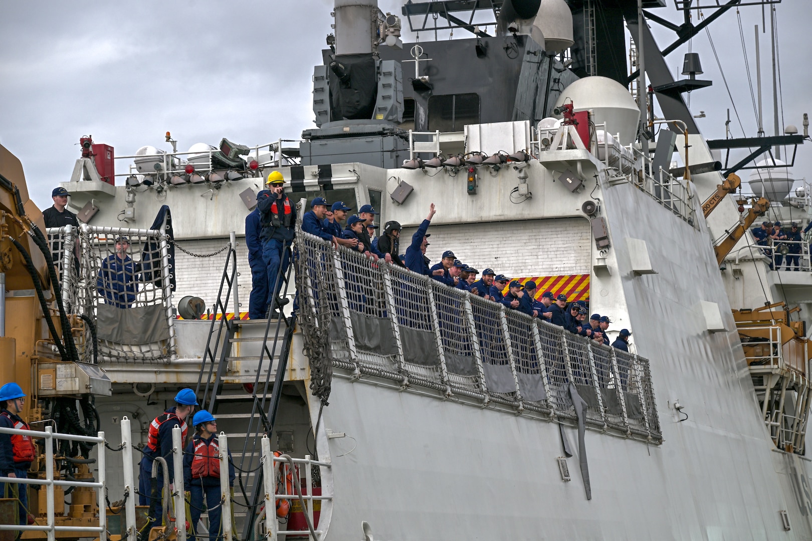 United States Coast Guard Cutter Bertholf (WMSL 750) crewmembers oversee docking evolutions, and wave at family members ashore in Alameda, California, Feb. 7, 2025. Bertholf’s crew returned after completing a 130-day deployment patrolling the Bering Sea. (U.S. Coast Guard photo by Petty Officer 3rd Class Austin Wiley.)