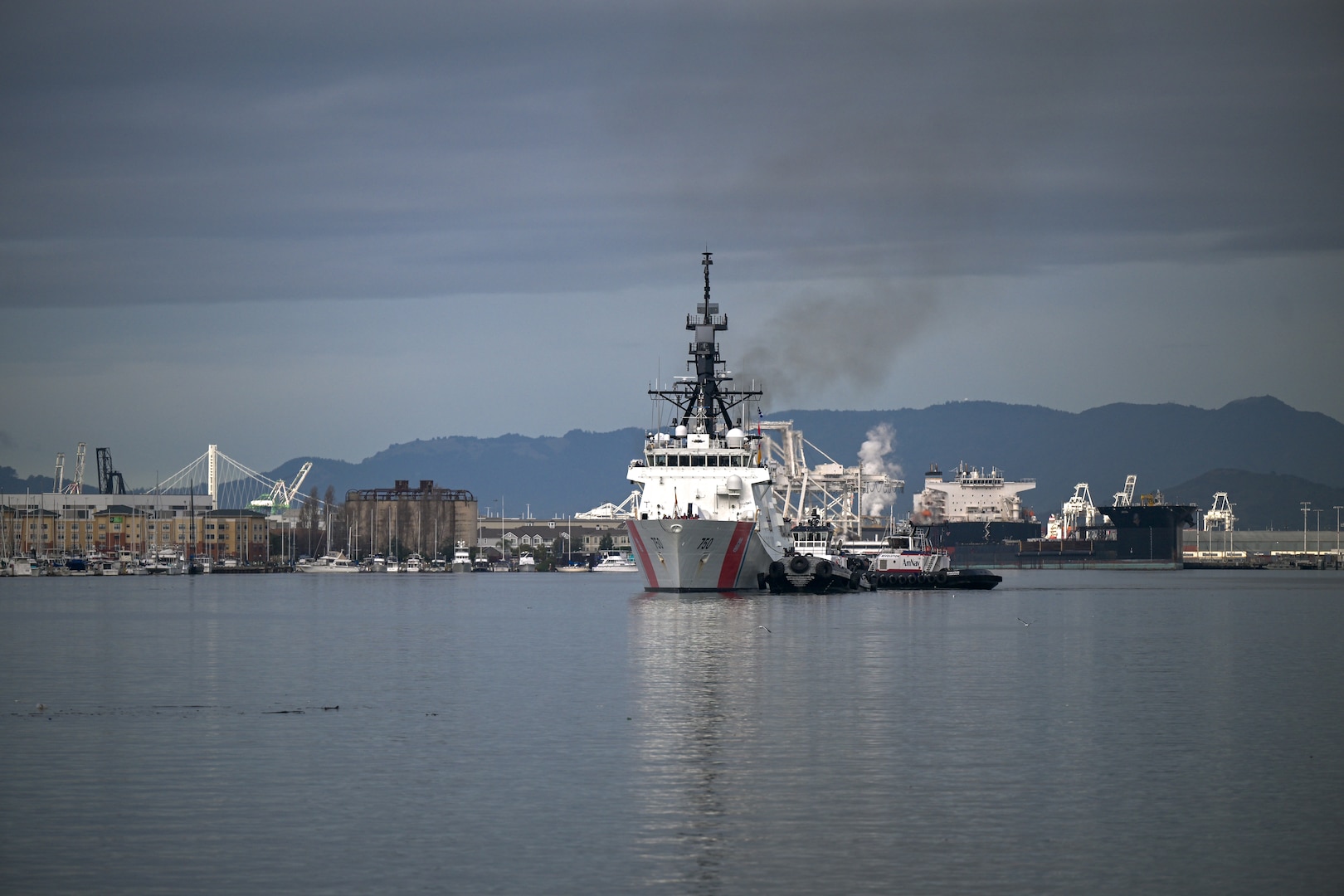 United States Coast Guard Cutter Bertholf (WMSL 750) is guided along the channel towards Coast Guard Island in Alameda, California, Feb. 7, 2025. Bertholf routinely conducts operations throughout the Pacific, where the cutter’s combination of range, speed, and ability to operate in extreme-weather conditions provides the mission flexibility necessary to conduct vital strategic missions. (U.S. Coast Guard photo by Petty Officer 3rd Class Austin Wiley.)