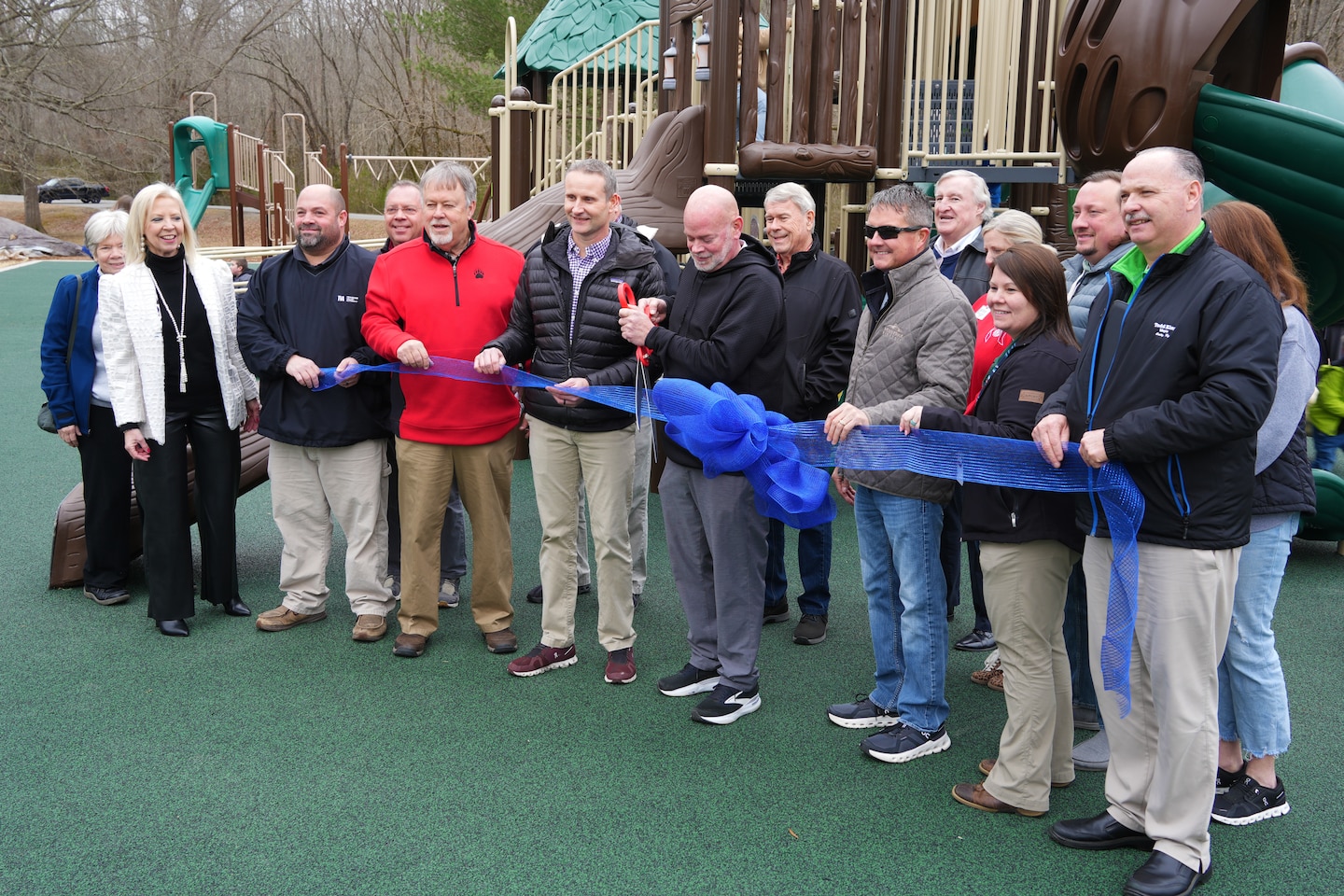 Jeff Hunter, director of Cadiz-Trigg County Parks and Recreation (center), cuts the ribbon to officially open the newly installed accessible playground at Cadiz Recreation Area on Feb. 7, 2025. Joining him are leaders and representatives from the U.S. Army Corps of Engineers, the City of Cadiz, Cadiz-Trigg County Parks and Recreation, Cadiz-Trigg County Tourism, and the Cadiz Rotary Club—partners who made this community-enhancing project possible.