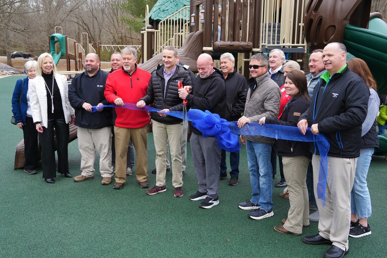 Jeff Hunter, director of Cadiz-Trigg County Parks and Recreation (center), cuts the ribbon to officially open the newly installed accessible playground at Cadiz Recreation Area on Feb. 7, 2025. Joining him are leaders and representatives from the U.S. Army Corps of Engineers, the City of Cadiz, Cadiz-Trigg County Parks and Recreation, Cadiz-Trigg County Tourism, and the Cadiz Rotary Club—partners who made this community-enhancing project possible.